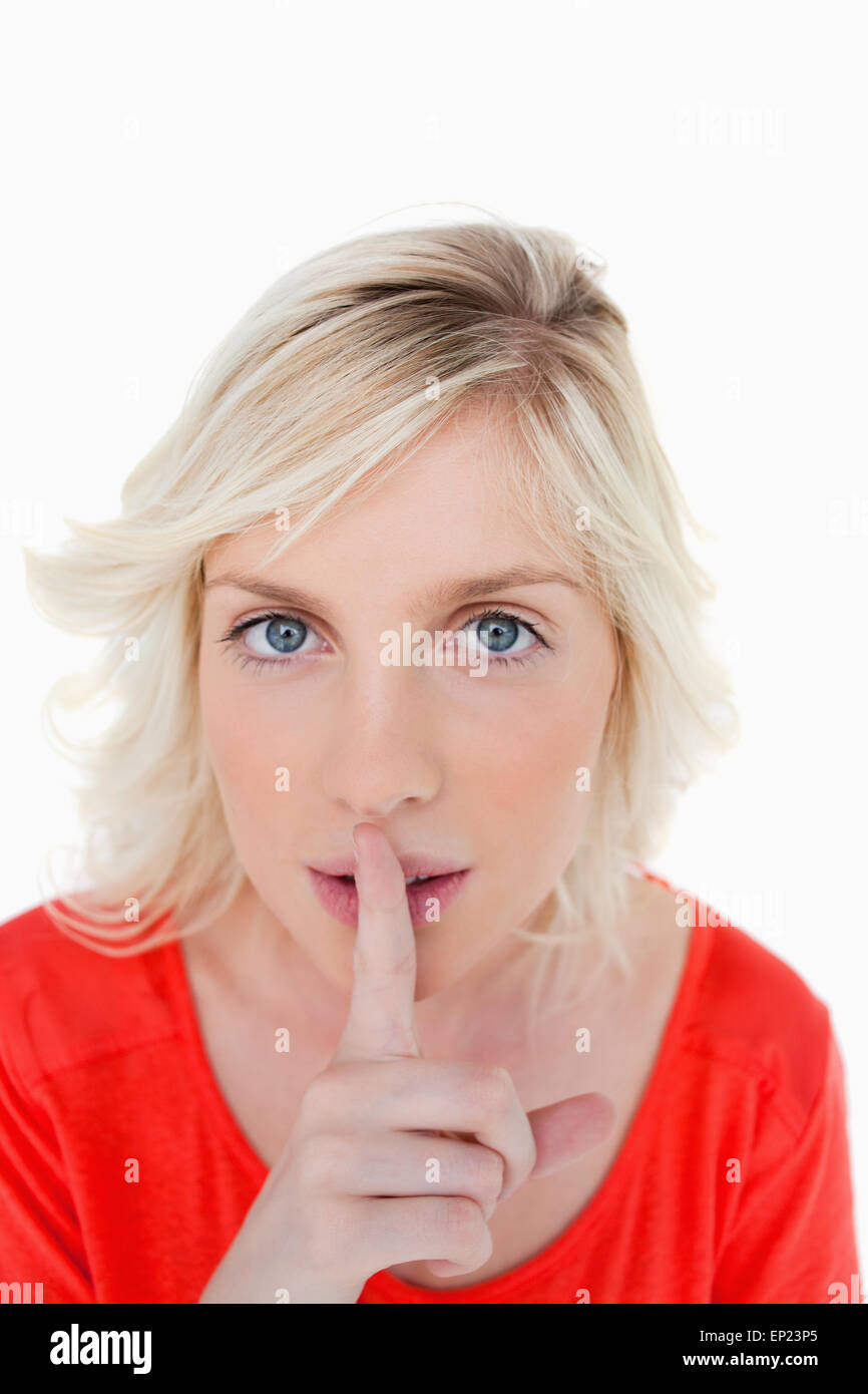 Very serious blonde woman telling to be quiet Stock Photo