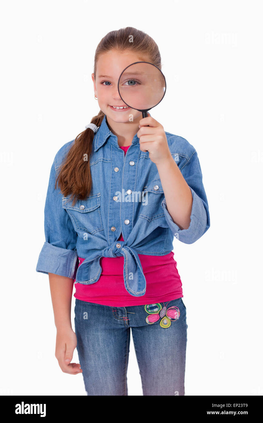 Portrait of a girl looking through a magnifying glass Stock Photo - Alamy