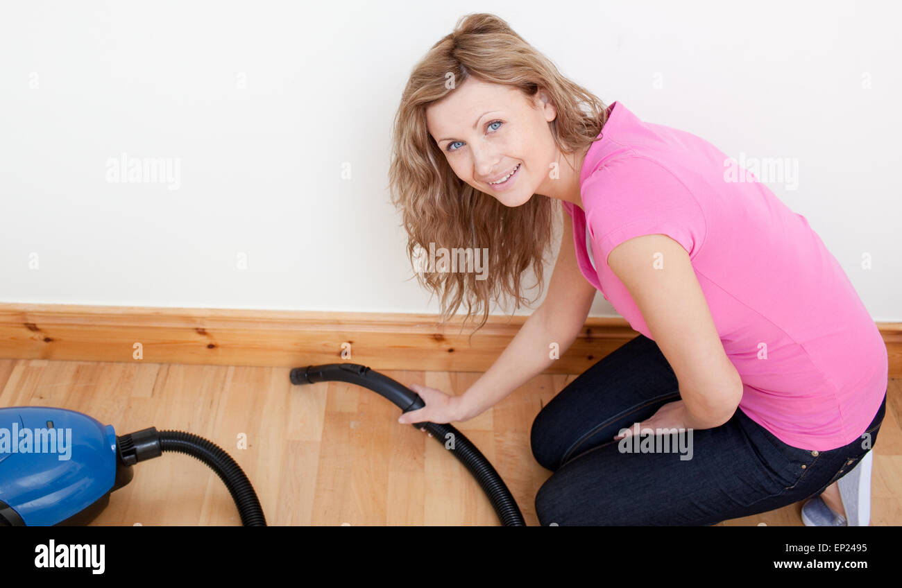 Portrait of a jolly woman vacuuming Stock Photo - Alamy