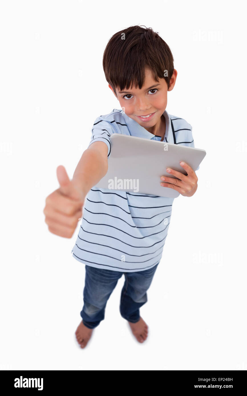 Portrait of a boy using a tablet computer with the thumb up Stock Photo