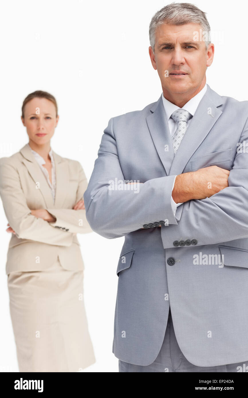 Serious business people standing with folded arms Stock Photo - Alamy