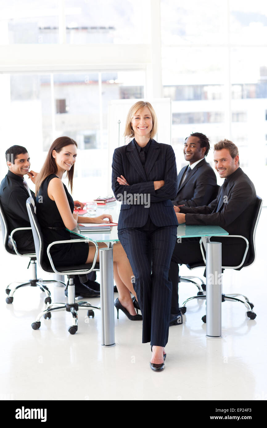 Business team smiling at the camera in a meeting Stock Photo - Alamy