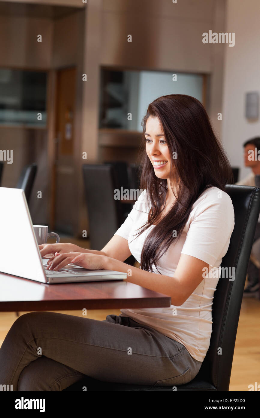 Portrait of a cute woman using a notebook Stock Photo - Alamy