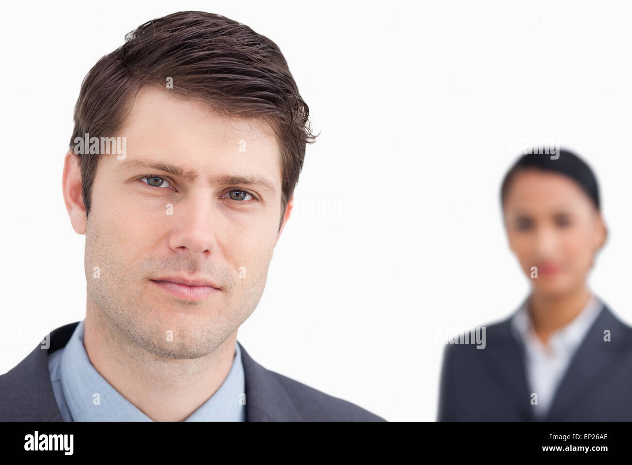 Close up of young salesman with colleague behind him Stock Photo - Alamy
