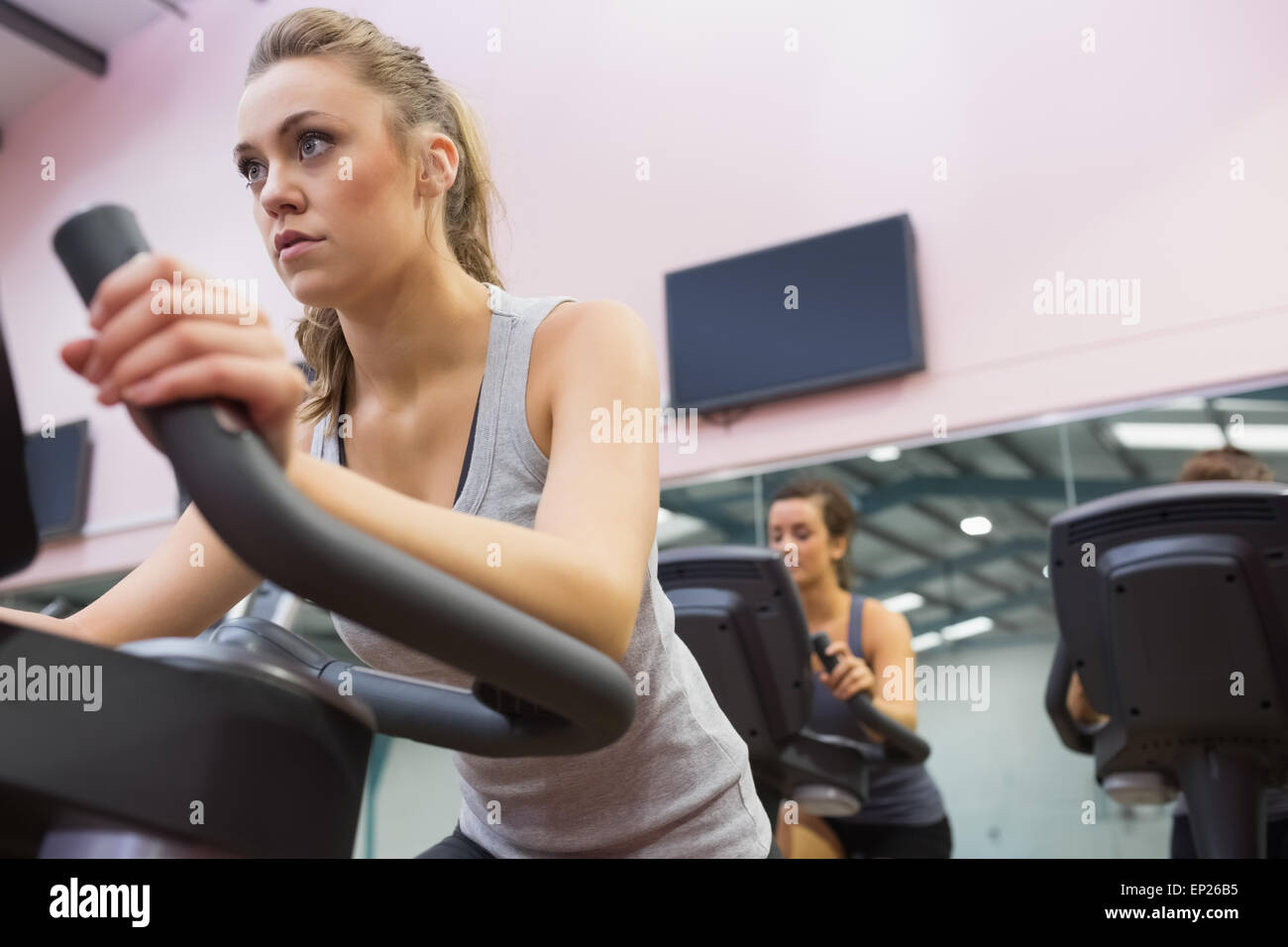 Woman training on exercise bike in a spinning class Stock Photo