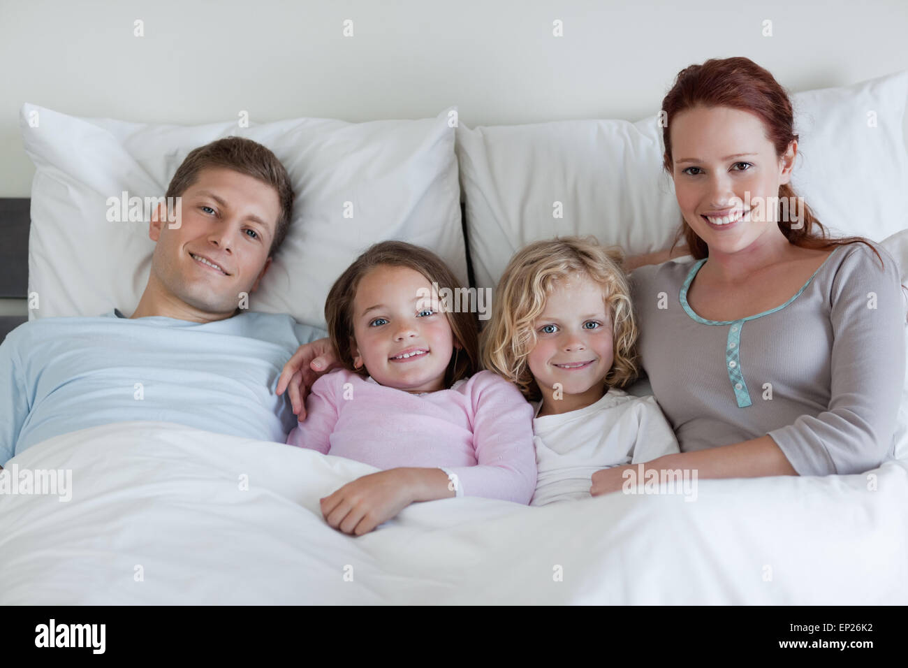 Family sharing the bed Stock Photo Alamy