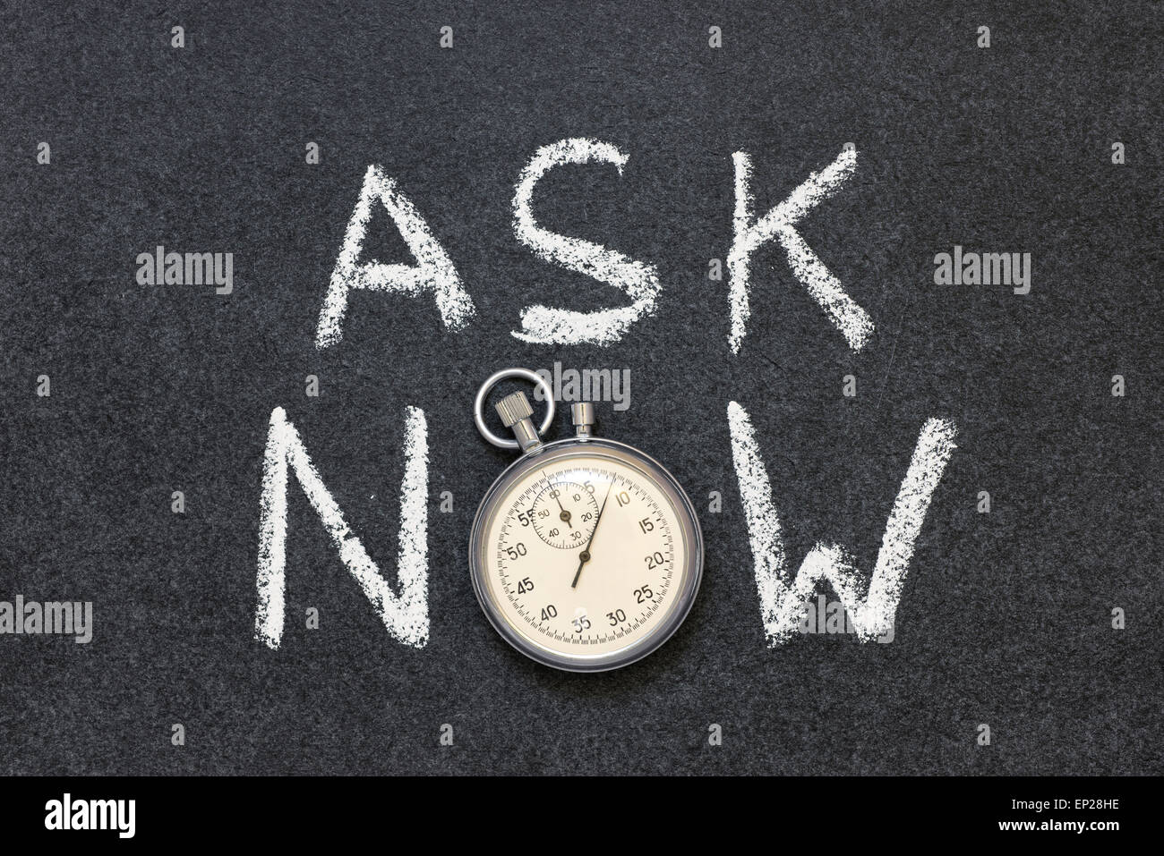 ask now phrase handwritten on chalkboard with vintage precise stopwatch used instead of O Stock Photo