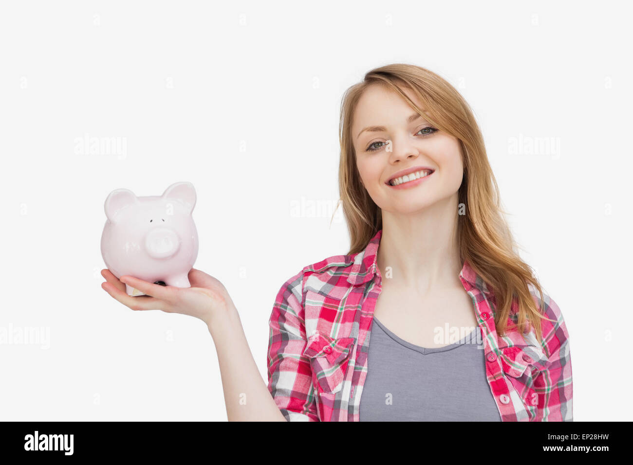 Woman holding a piggy bank while looking at camera Stock Photo - Alamy