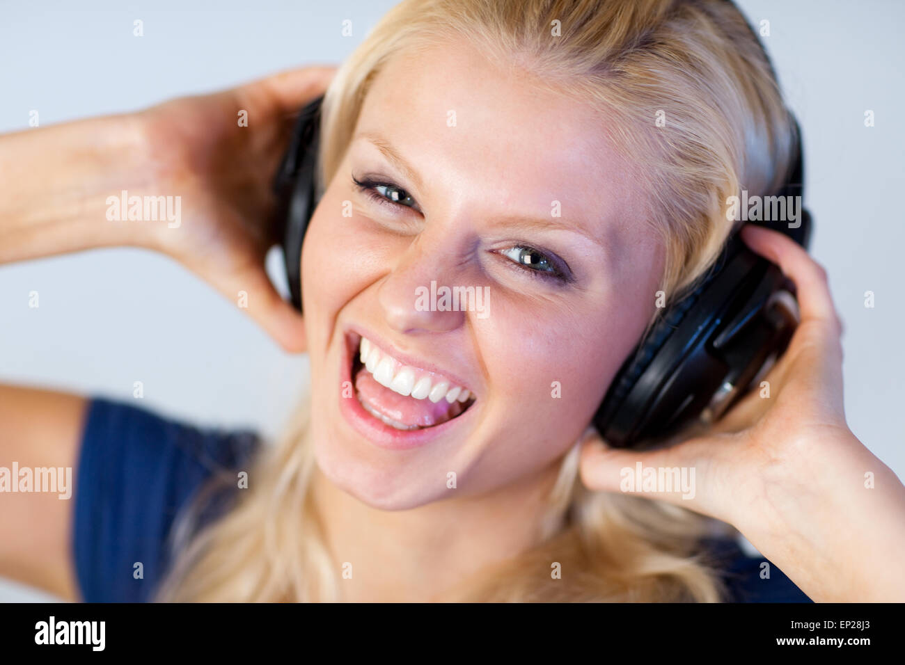 Cheerful woman listening music with headphones Stock Photo - Alamy
