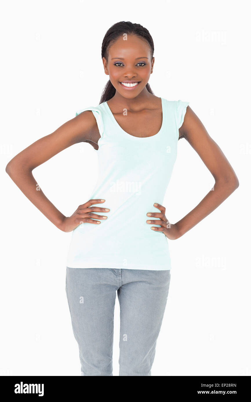 Close up of woman with arms akimbo on white background Stock Photo