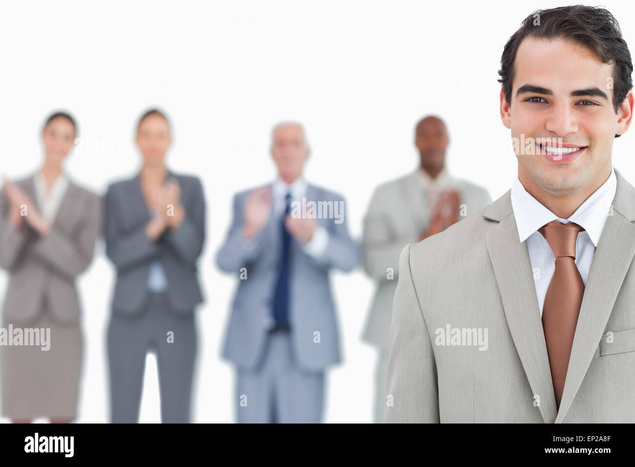 Businessman with applauding colleagues behind him Stock Photo - Alamy