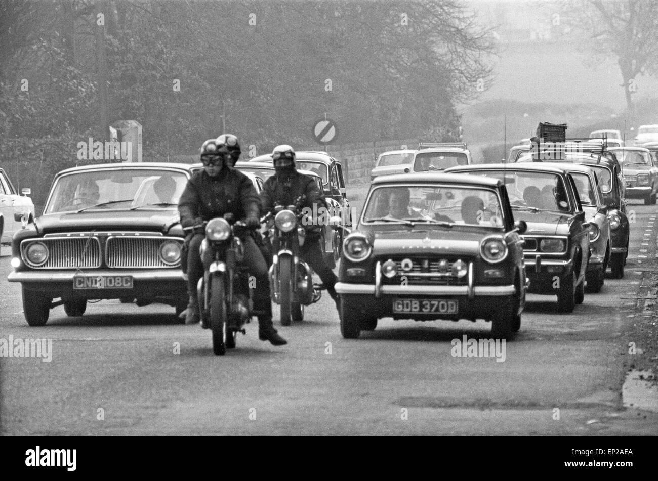 Traffic including three motorcyclists stop and queue along the A556 towards Manchester, as holiday makers poured home from North Wales after a sizzling Easter Bank Holiday Monday. 7th April 1969. Stock Photo