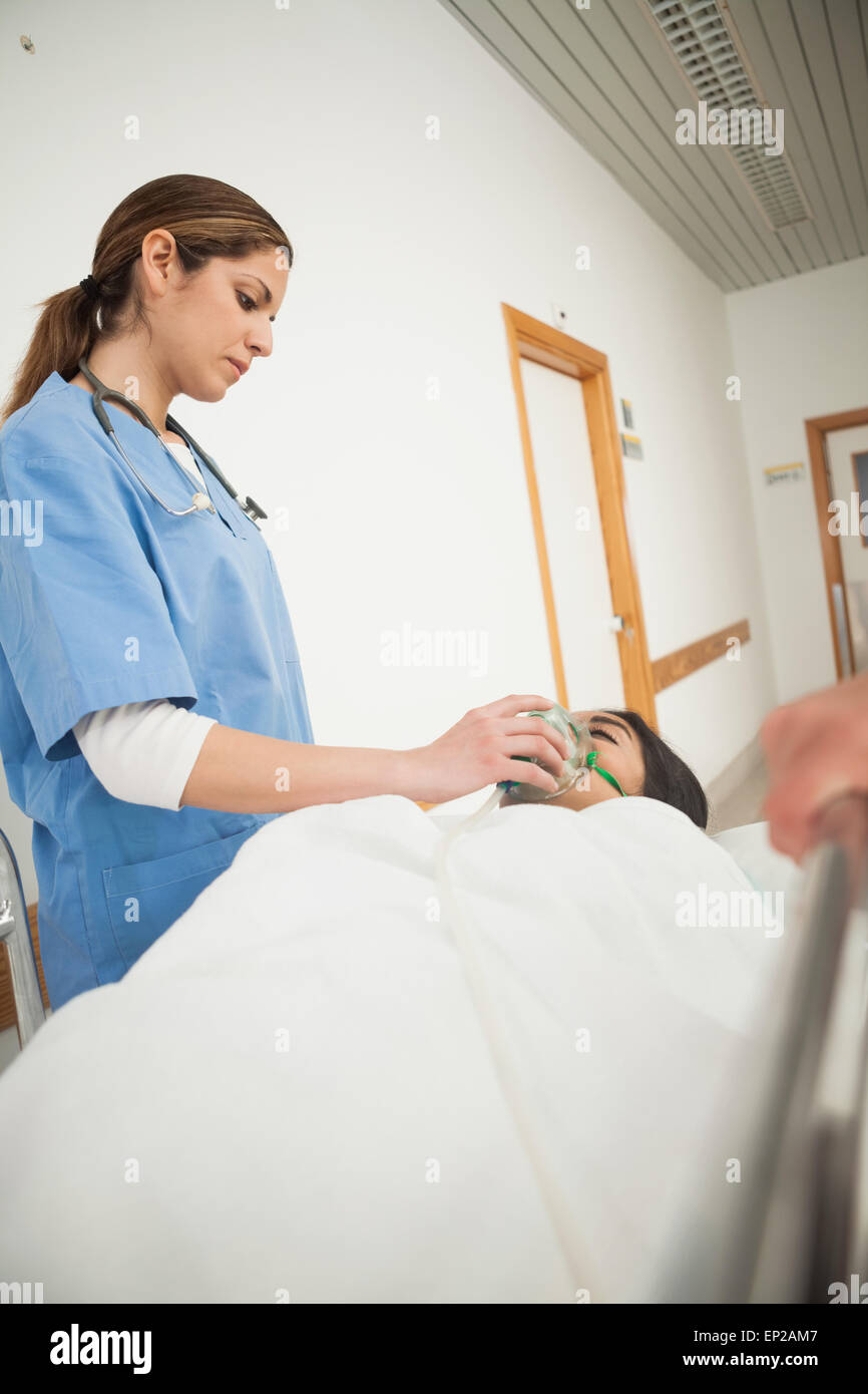 Nurse putting oxygen mask on a female patient Stock Photo - Alamy