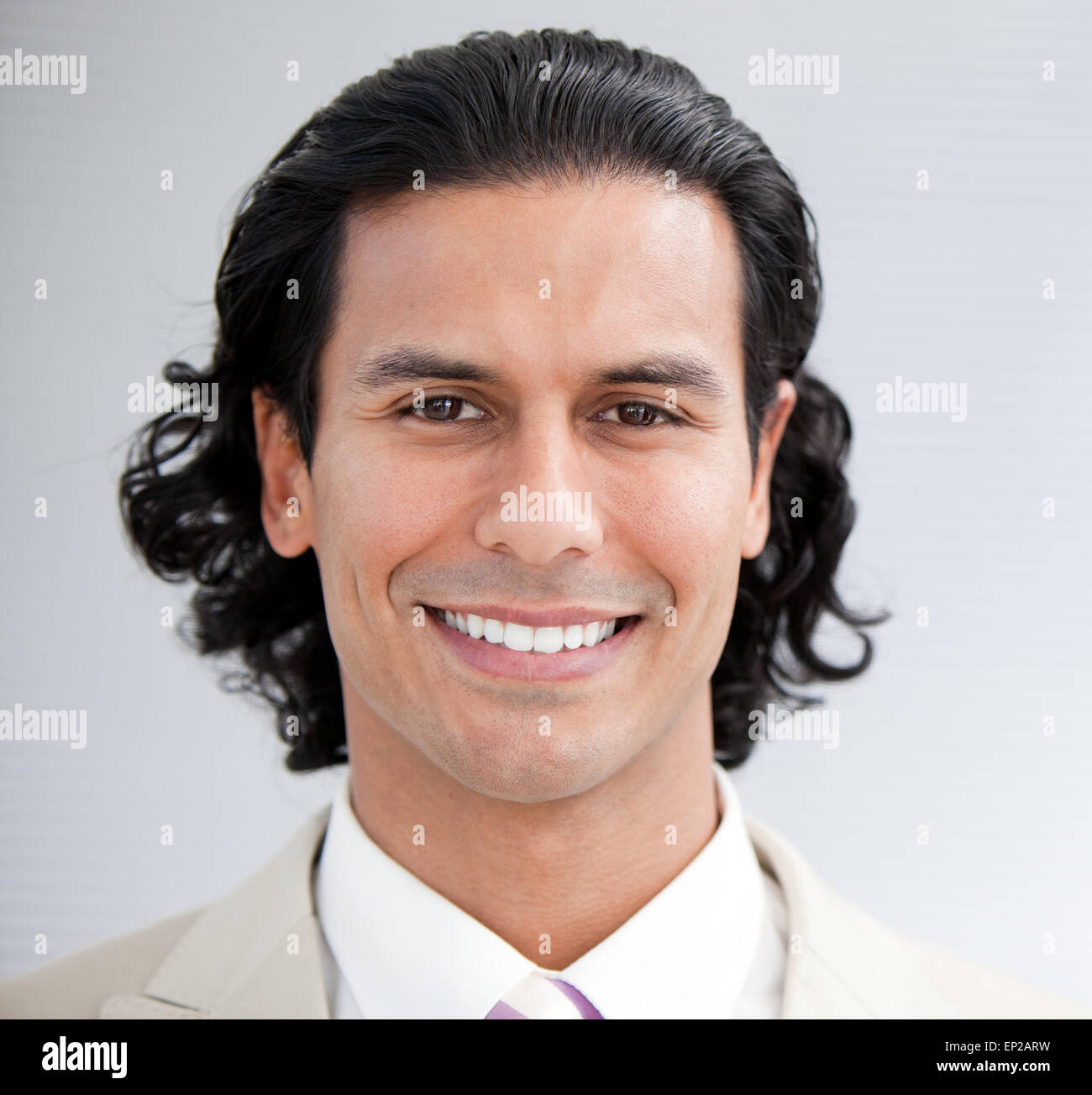 Confident businessman smiling at the camera Stock Photo - Alamy