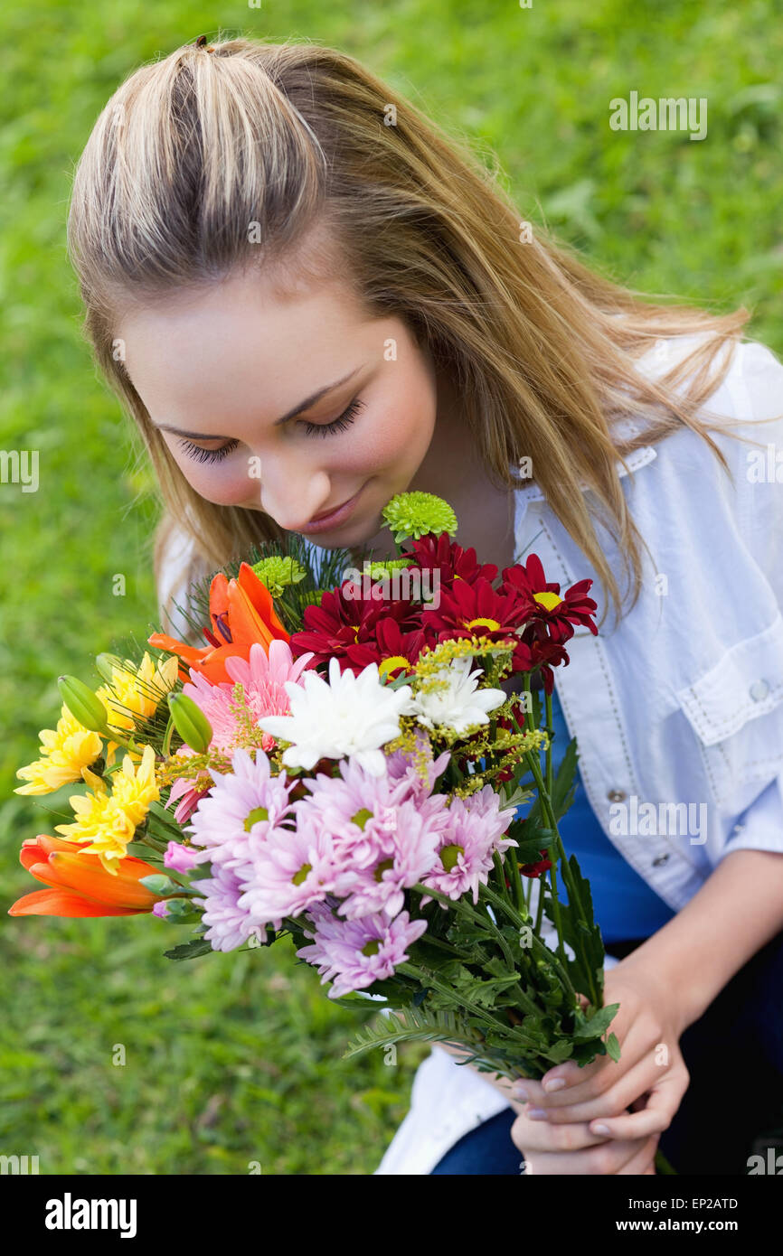 Young attractive girl smelling a bunch of flower Stock Photo - Alamy