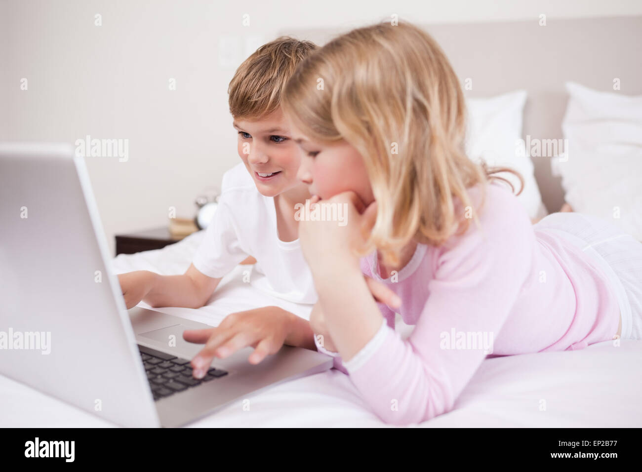 Smiling children using a laptop Stock Photo - Alamy