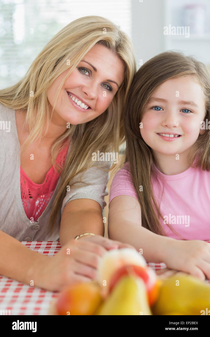 Mother and child sitting at kitchen table smiling Stock Photo Alamy