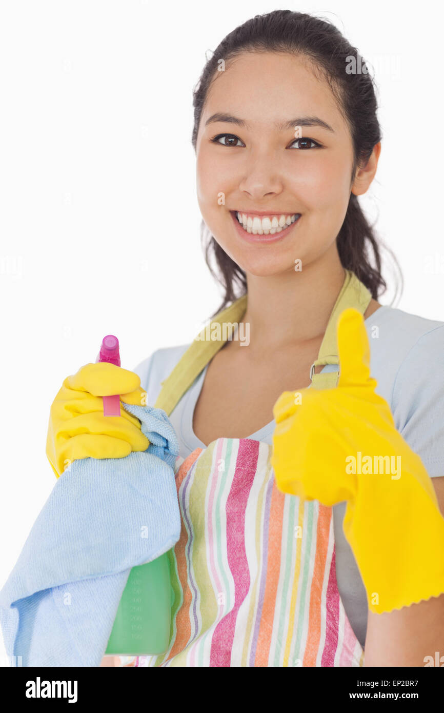 Smiling woman with cleaning products giving thumbs up Stock Photo Alamy