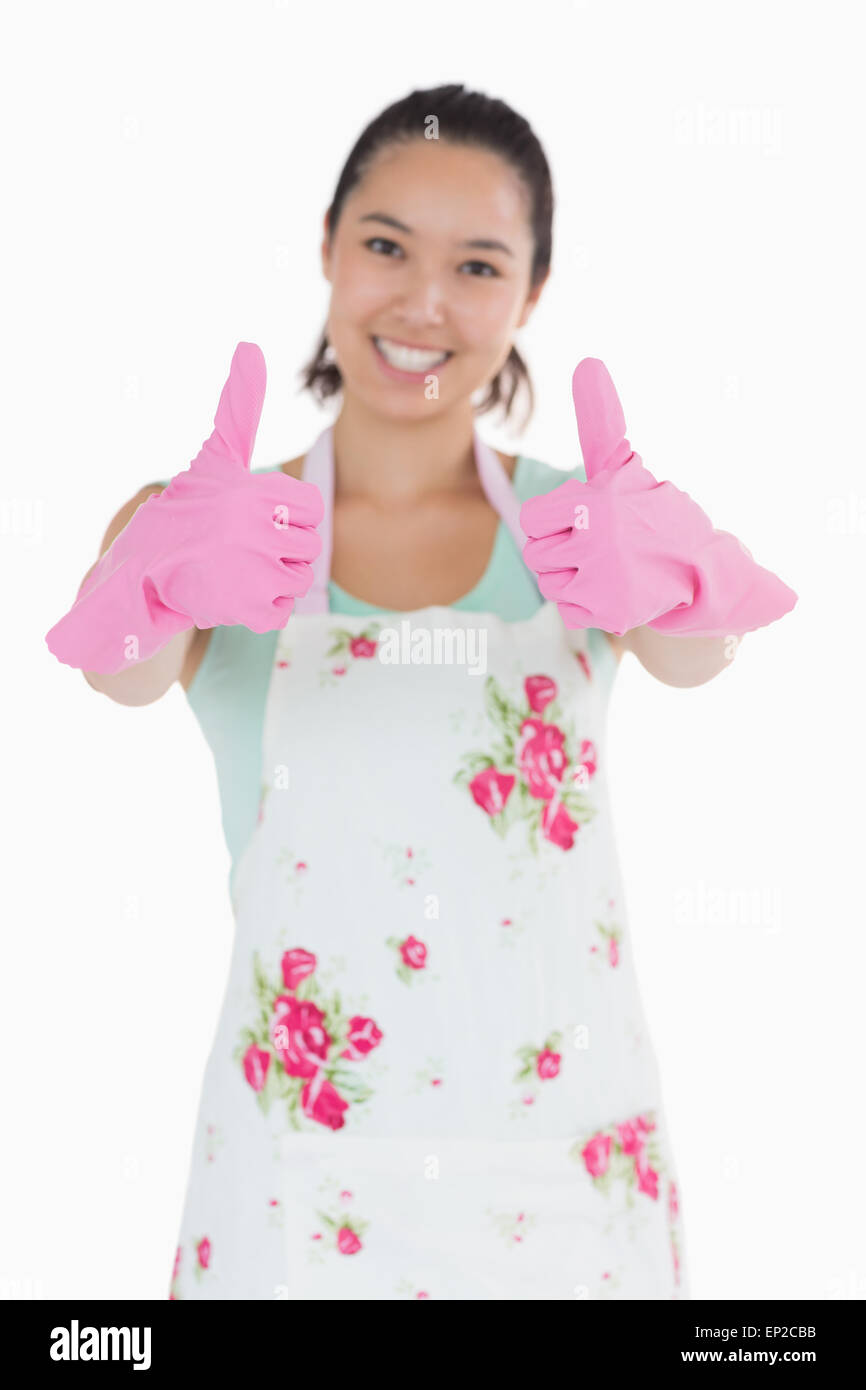 Happy woman in rubber gloves giving thumbs up Stock Photo - Alamy