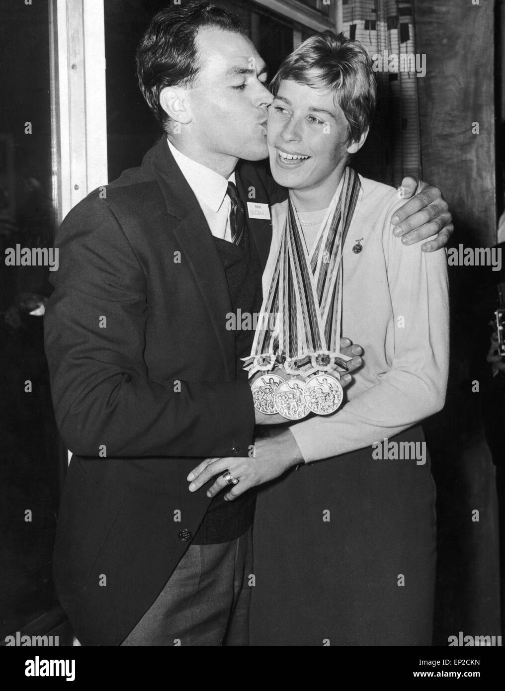 Tokyo Gold Medalist Mary Rand is met by her husband Sid on her return from the Olympic Games. 20th October 1964 Stock Photo
