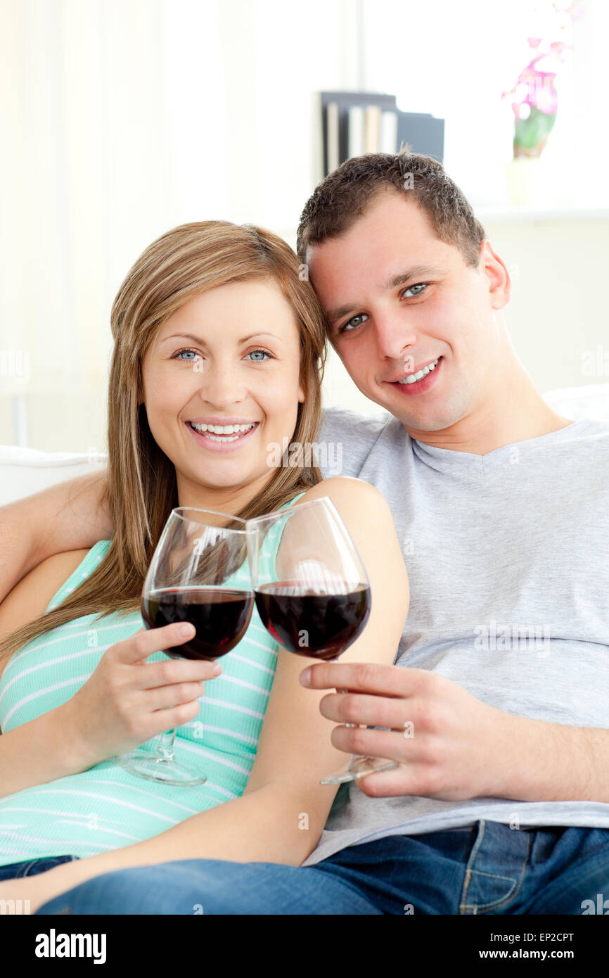 Portrait of a happy young couple drinking red wine Stock Photo - Alamy