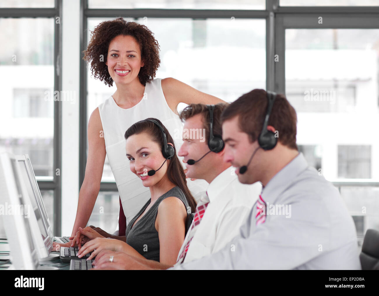 Self-assured female manager with her sale representative team Stock Photo