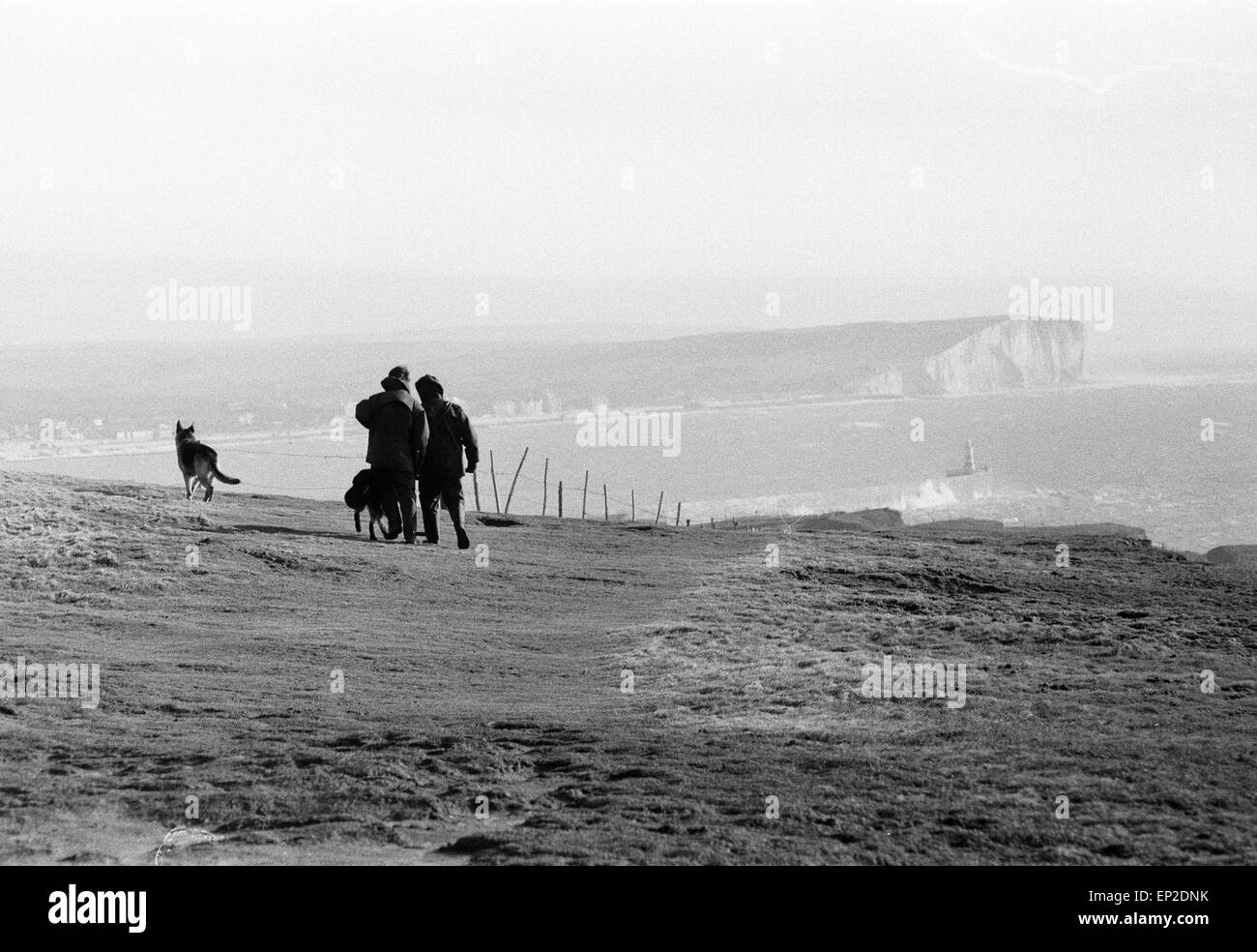 Police Manhunt in Newhaven Sussex 25th November 1974. Police with tracker dogs search cliff tops and harbour for missing Lord Lucan now wanted on murder charge. Richard John Bingham 7th Earl of Lucan popularly known as Lord Lucan was British peer who disappeared in the early hours of 8 November 1974 following the murder of Sandra Rivett his children's nanny the previous evening. There has been no verified sighting of him since then. On 19th June 1975 an inquest jury named Lucan as the murderer of Sandra Rivett. He was presumed deceased in chambers on 11th December 1992 & declared legally dead. Stock Photo