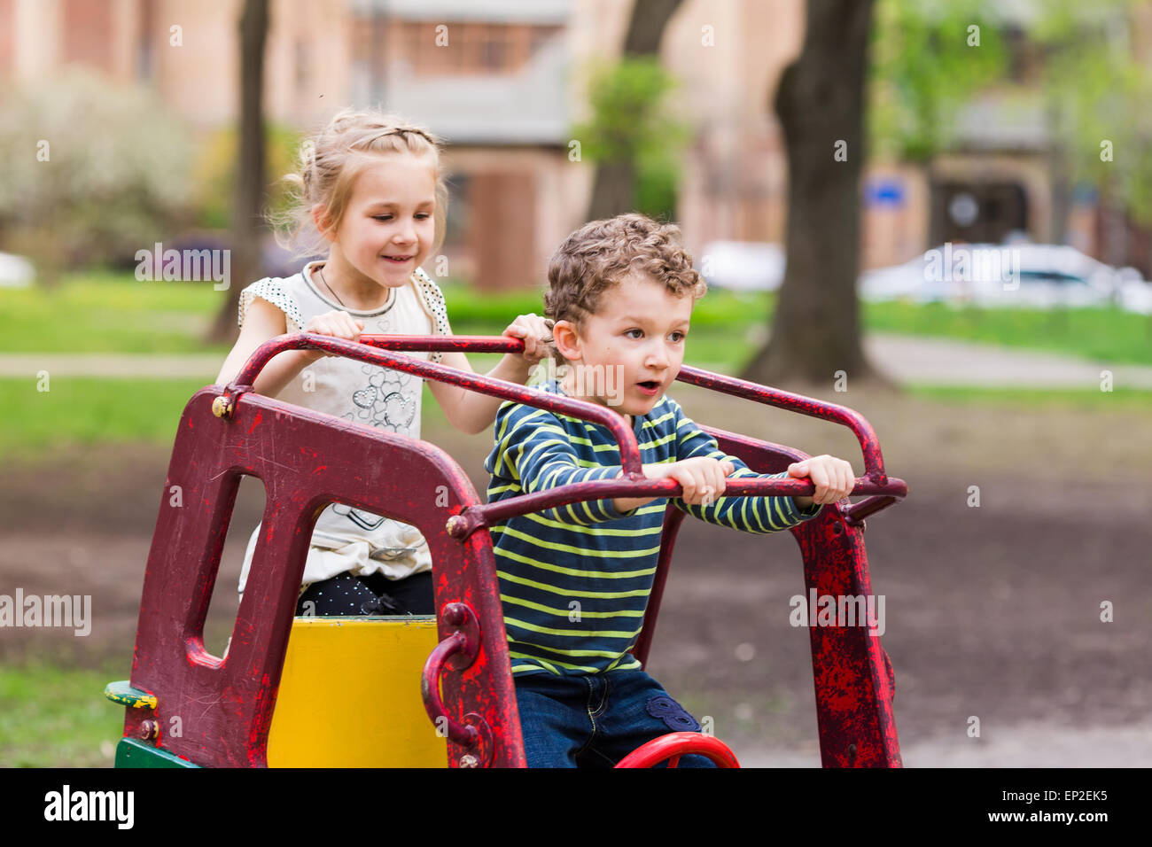 Kid Drive Excited happy kids driving a toy car outdoor Stock Photo - Alamy