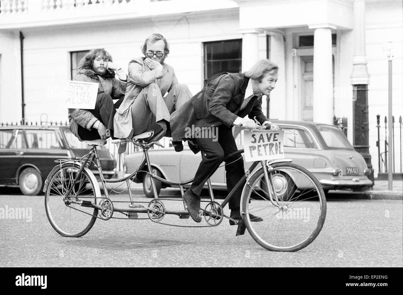 The Goodies, on the perfect answer to petrol rationing, ride their three seater tandem bicycle in London, Wednesday 21st November 1973. The Goodies Trio are Tim Brooke-Taylor, Graeme Garden & Bill Oddie. Stock Photo