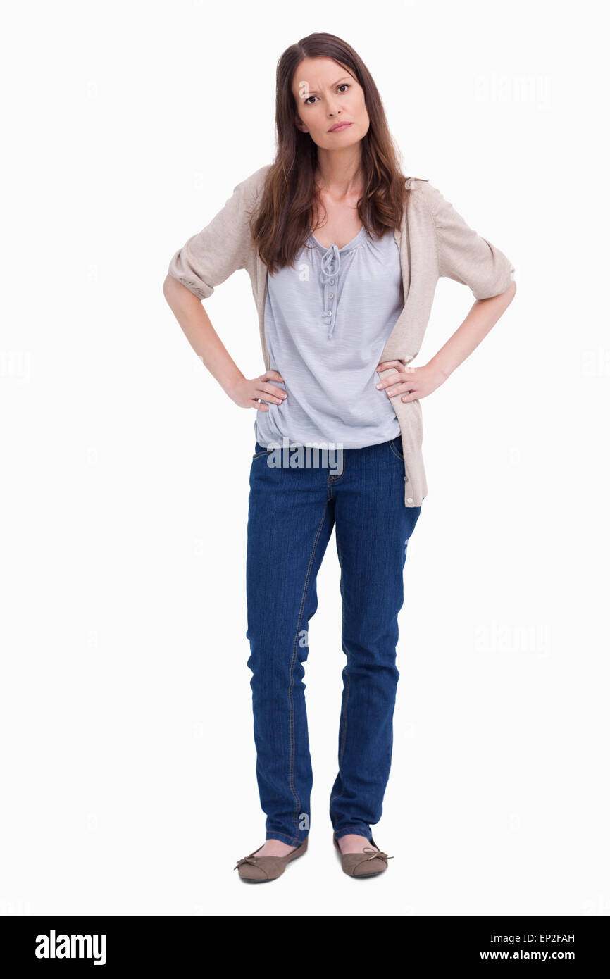 Serious looking woman with her hands on her hip Stock Photo