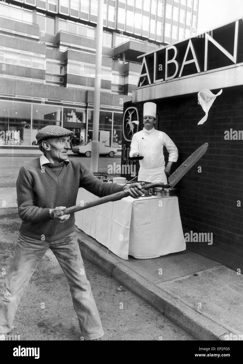 Chef Frank Boggie of the Albany Hotel, Glasgow, Scotland, almost met his match when he cooked up Shrove Tuesday pancakes. Workman Willie Duffy reconed anything Frank could do, he could do better ... even with a shovel, 23rd February 1982. Stock Photo