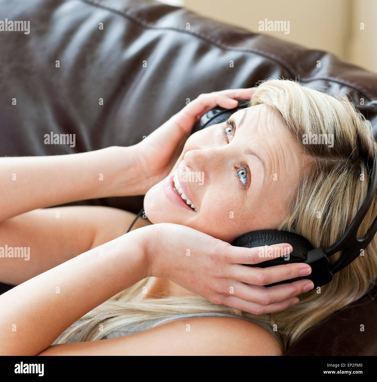 Smiling woman using headphones Stock Photo - Alamy