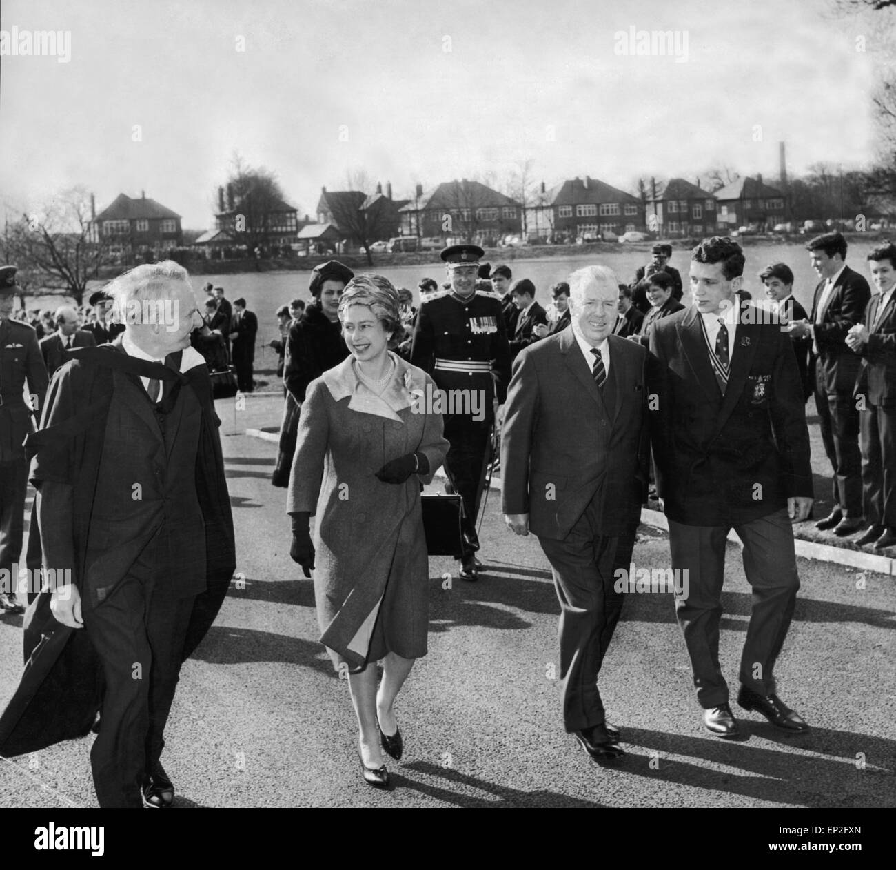 Another happy picture, on her arrival at the main gates of the school the Queen is greeted by the High Master with Lord Derby (left) Mr J H King chairman of govenors and Stephen Schaefer, the school Captain. March 1965. Stock Photo
