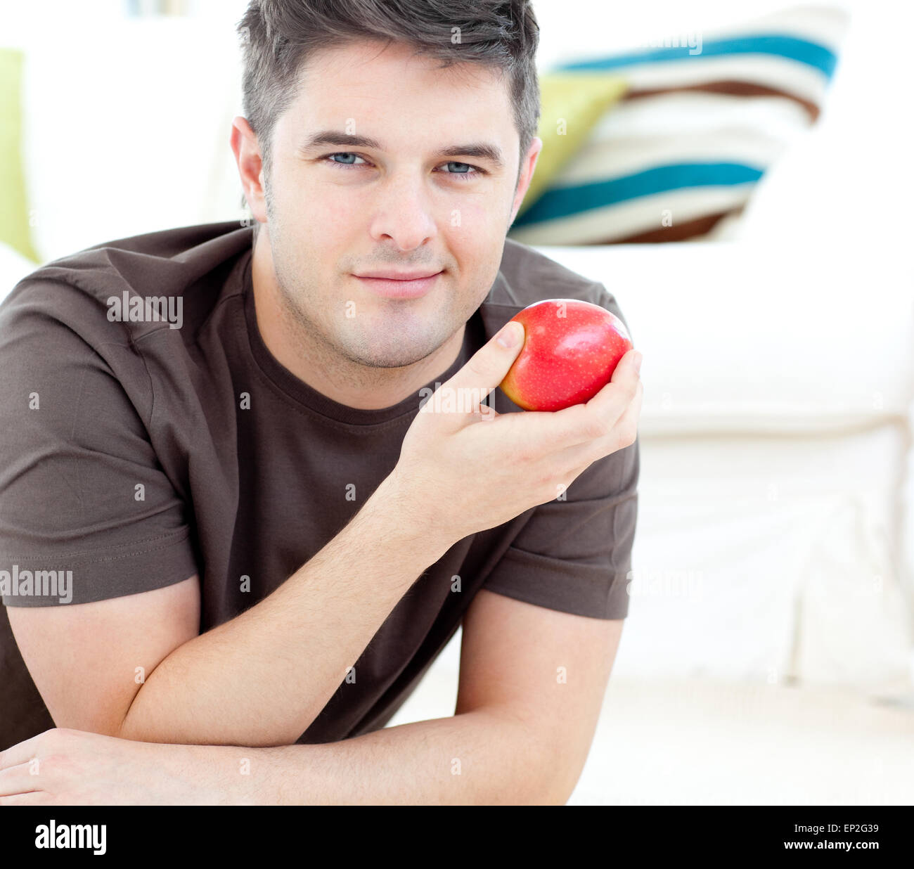 Man lying on sofa eating apple hi-res stock photography and images - Alamy