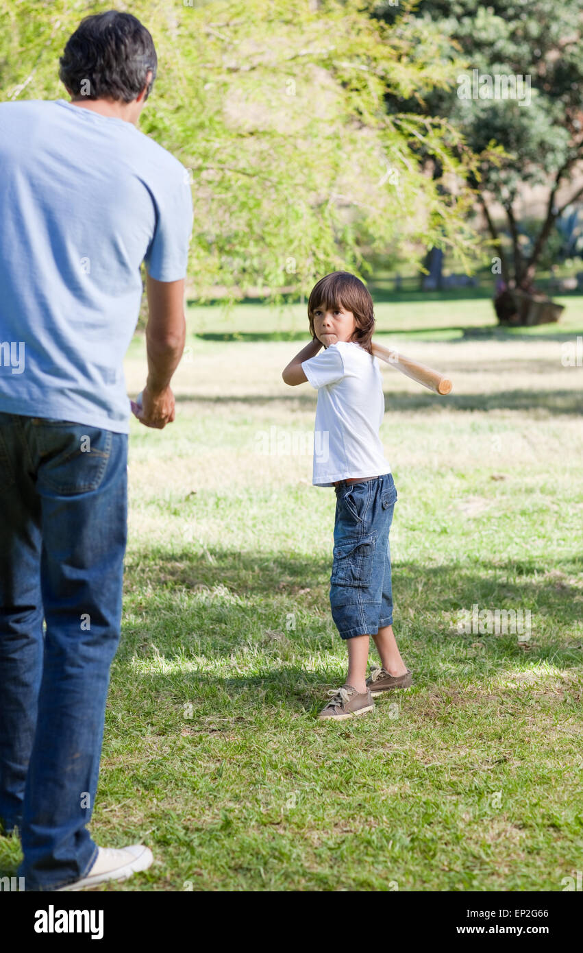 Merry little boy playing baseball with his father Stock Photo