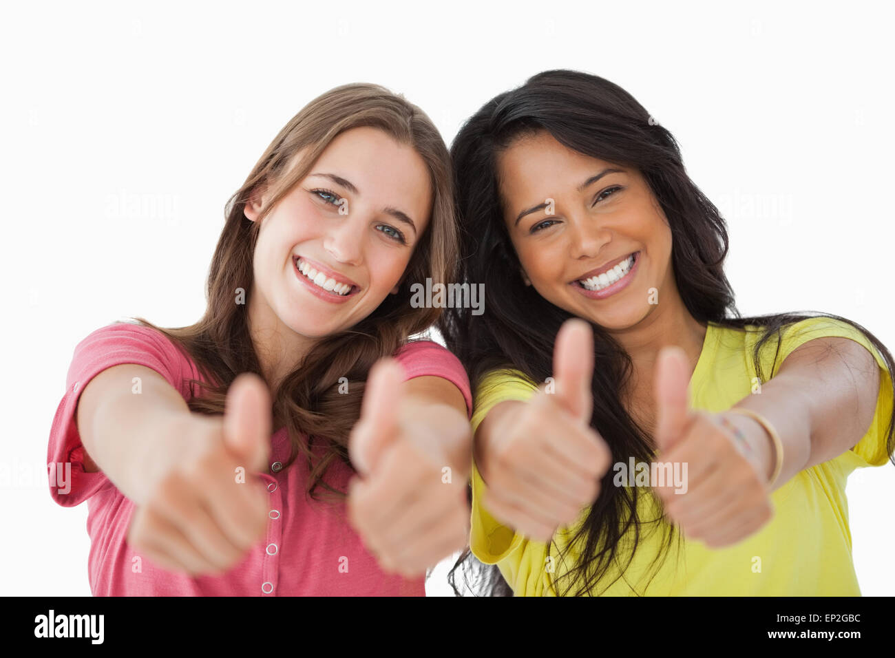 Portrait of two female students the thumbs-up Stock Photo - Alamy