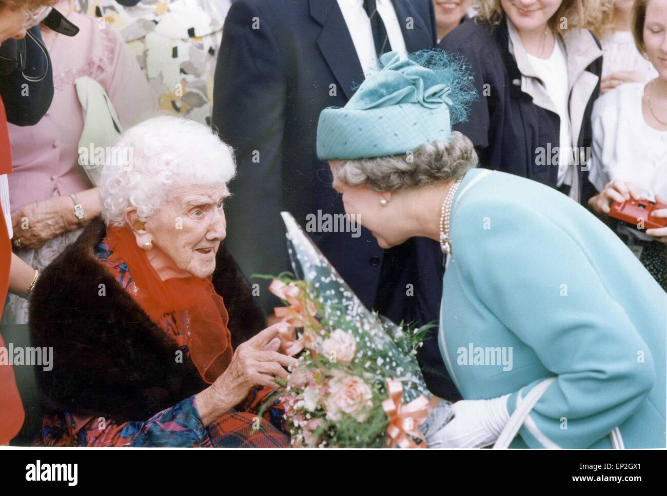 The Queen Visits Manchester. Chair bound Fay Gradwell made a special visit to Bury today. On her 100th Birthday she had come to see the queen who she had recieved a telegram from that morning. As the Queen commented that it was lovely to see her and she must not bother to stand up. In photo Derek Robson, step son in law. Ann RObson step daughter and the 100 year old Fay Gradwell who lives at Carrwood Nursing Home Bramhall. 17th July 1992. Stock Photo