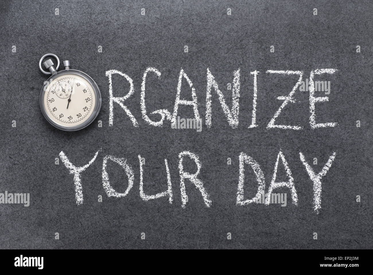 organize your day phrase handwritten on chalkboard with vintage precise stopwatch used instead of O Stock Photo