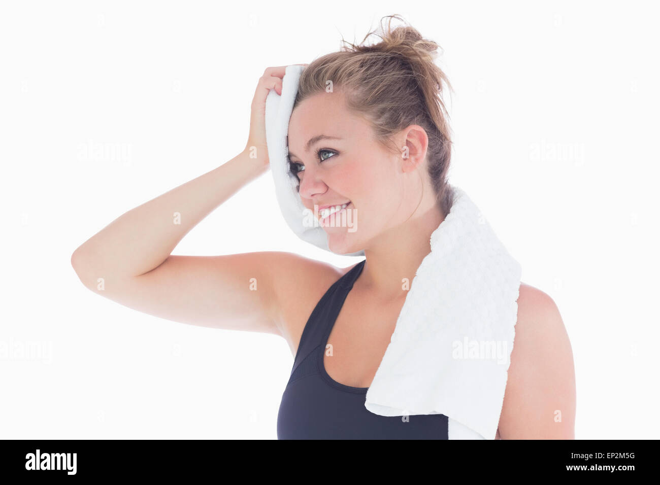 Woman smiling while holding towel at her forehead Stock Photo
