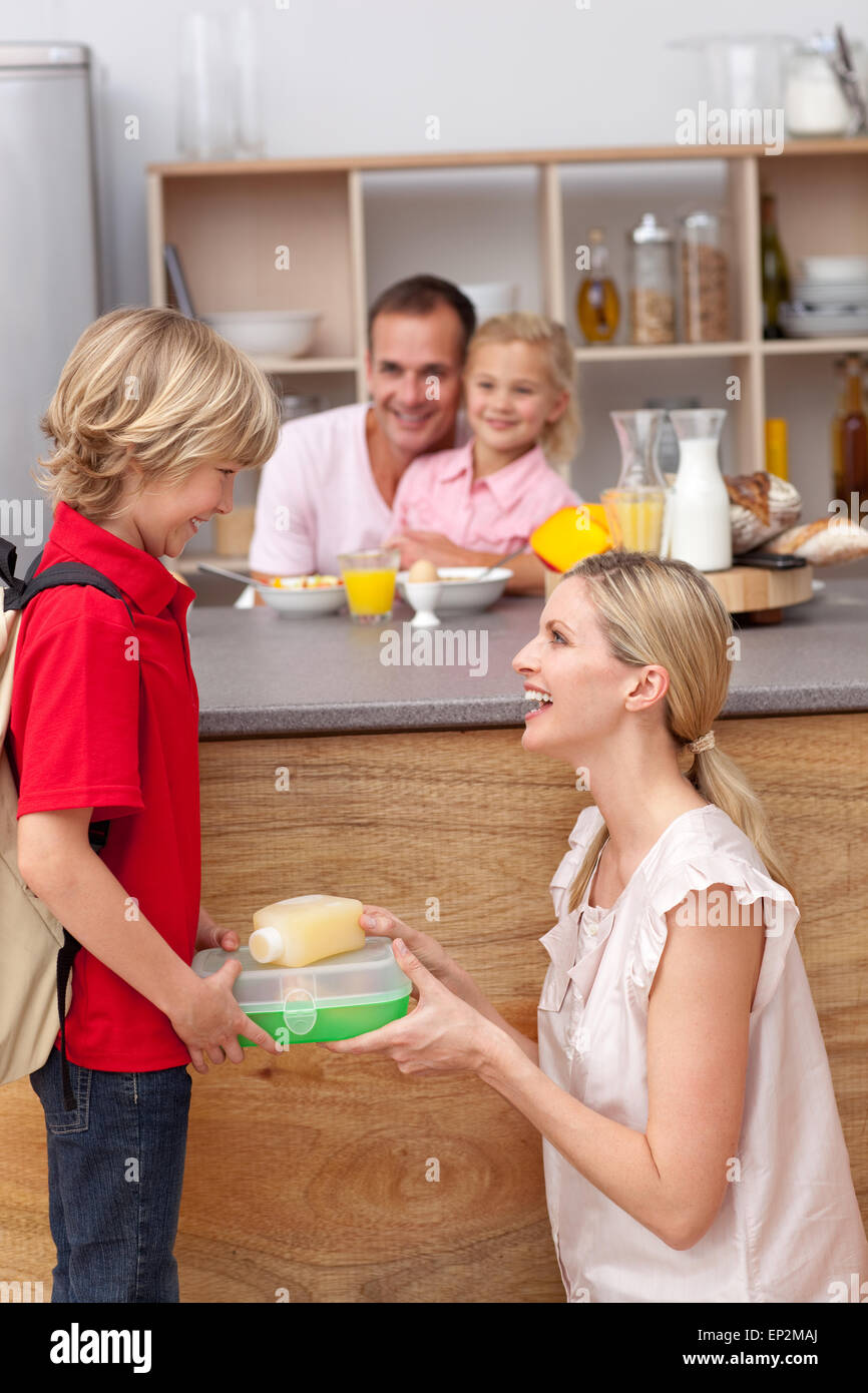 Caring mother packing the school lunch to his son Stock Photo