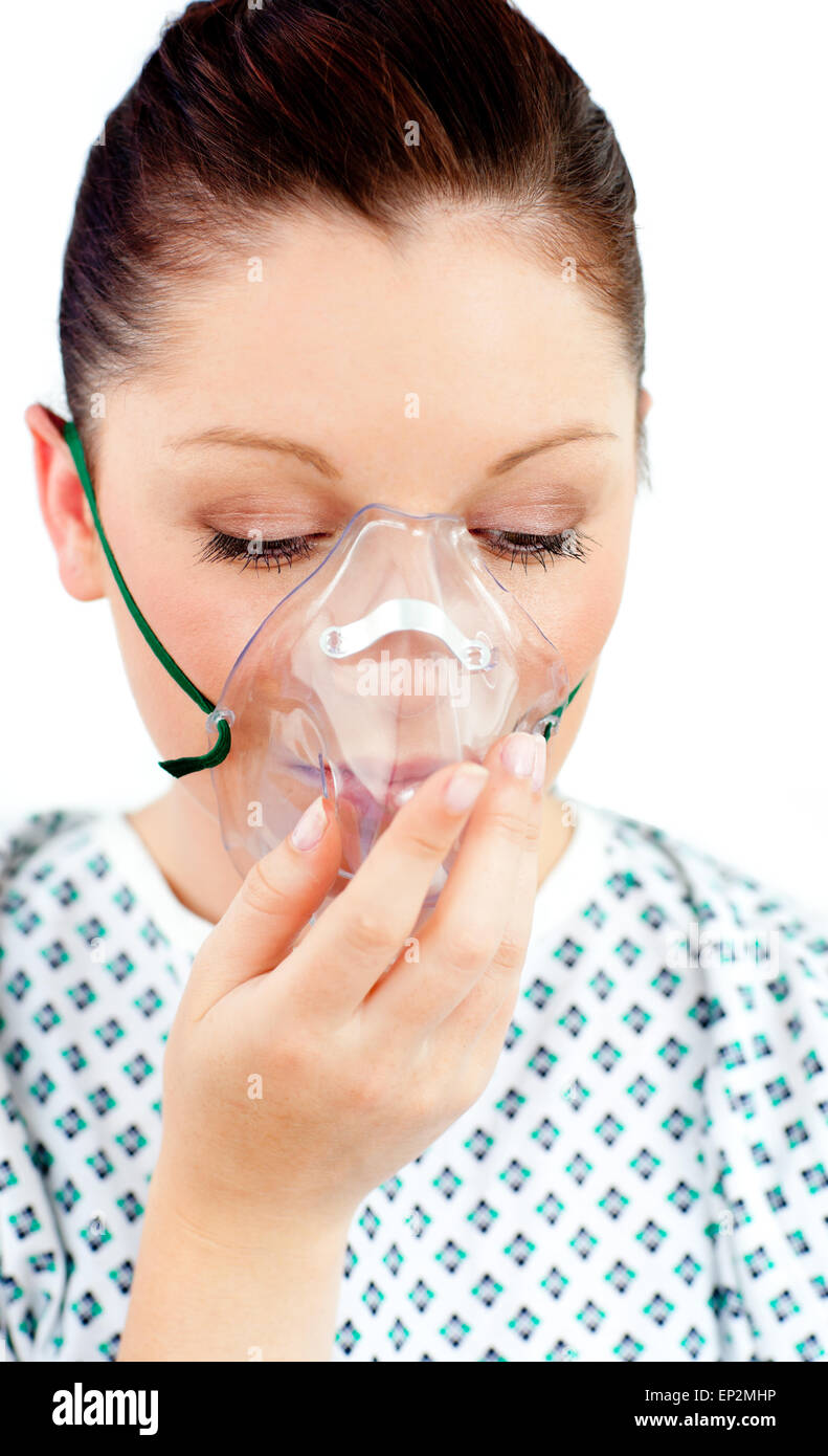 Diseased female patient wearing a oxygen mask against white background ...