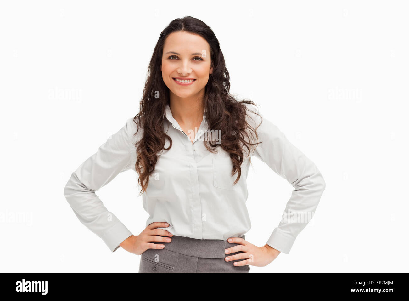 Portrait of a brunette businesswoman hands on hips smiling Stock Photo ...