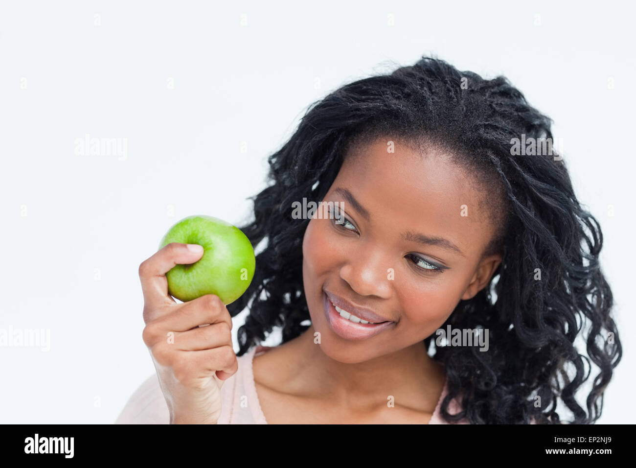 A woman is looking at an apple she is holding Stock Photo - Alamy