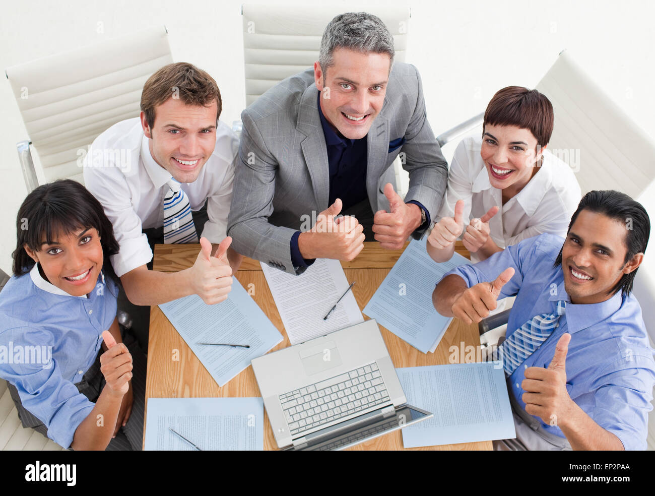 High angle of a cheerful business team with thumbs up Stock Photo - Alamy