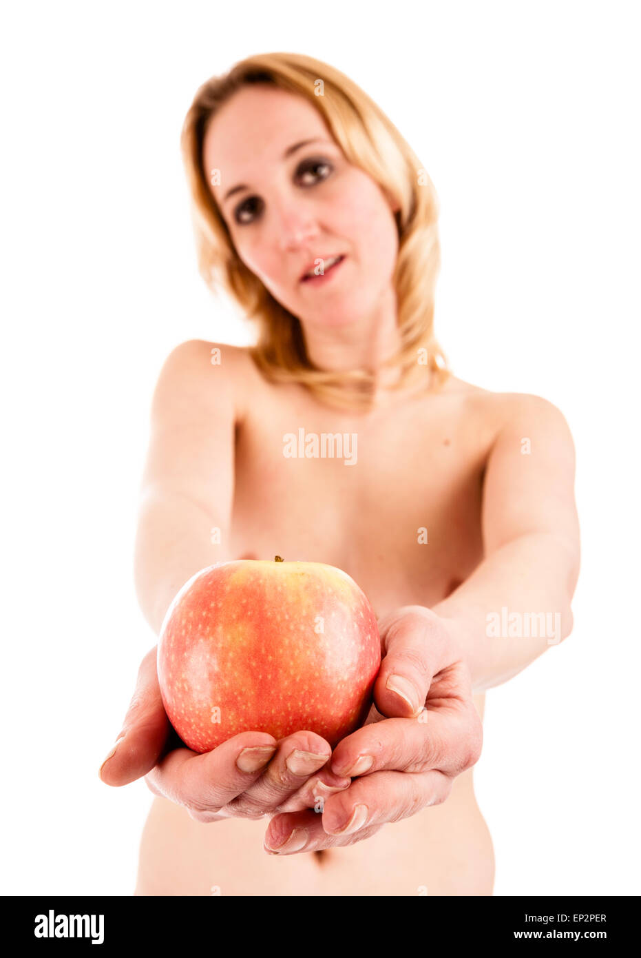 Temptation - a young naked woman offering an apple Stock Photo