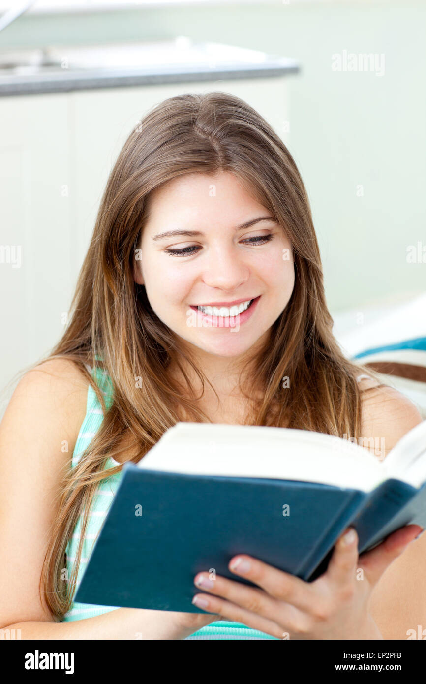 Bright caucasian woman reading a book at home Stock Photo - Alamy