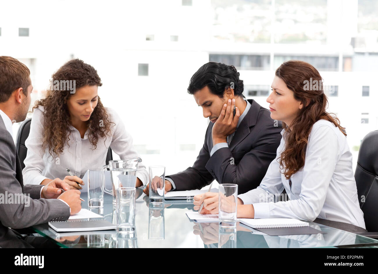Multi ethnic business team working together during a meeting Stock ...
