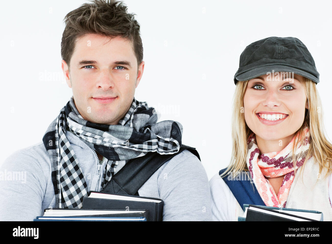 Portraits of two students holding books and smiling at the camera Stock ...