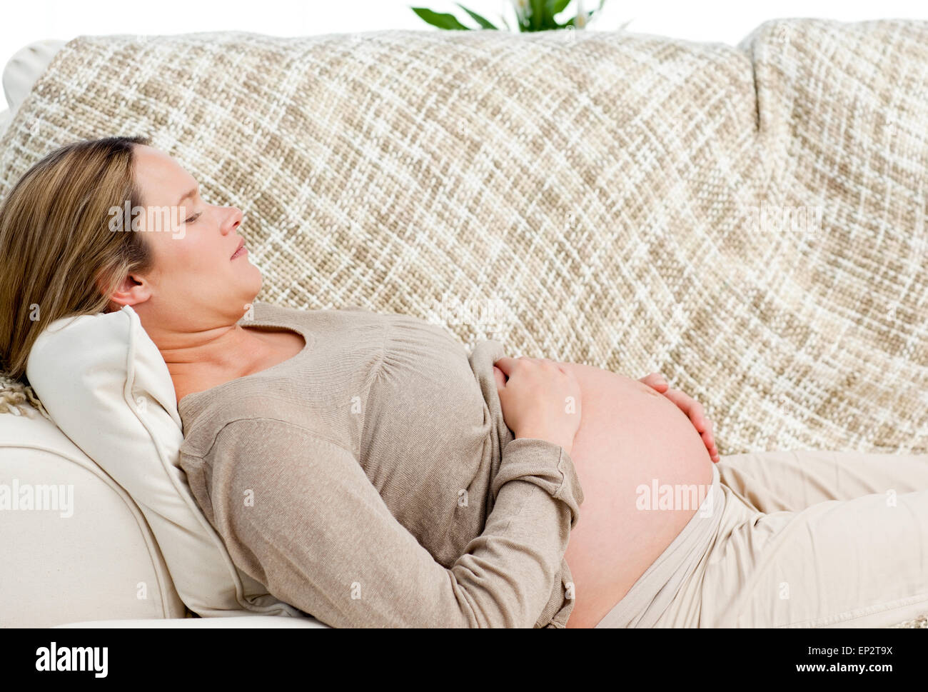Tired pregnant woman relaxing on her sofa Stock Photo Alamy