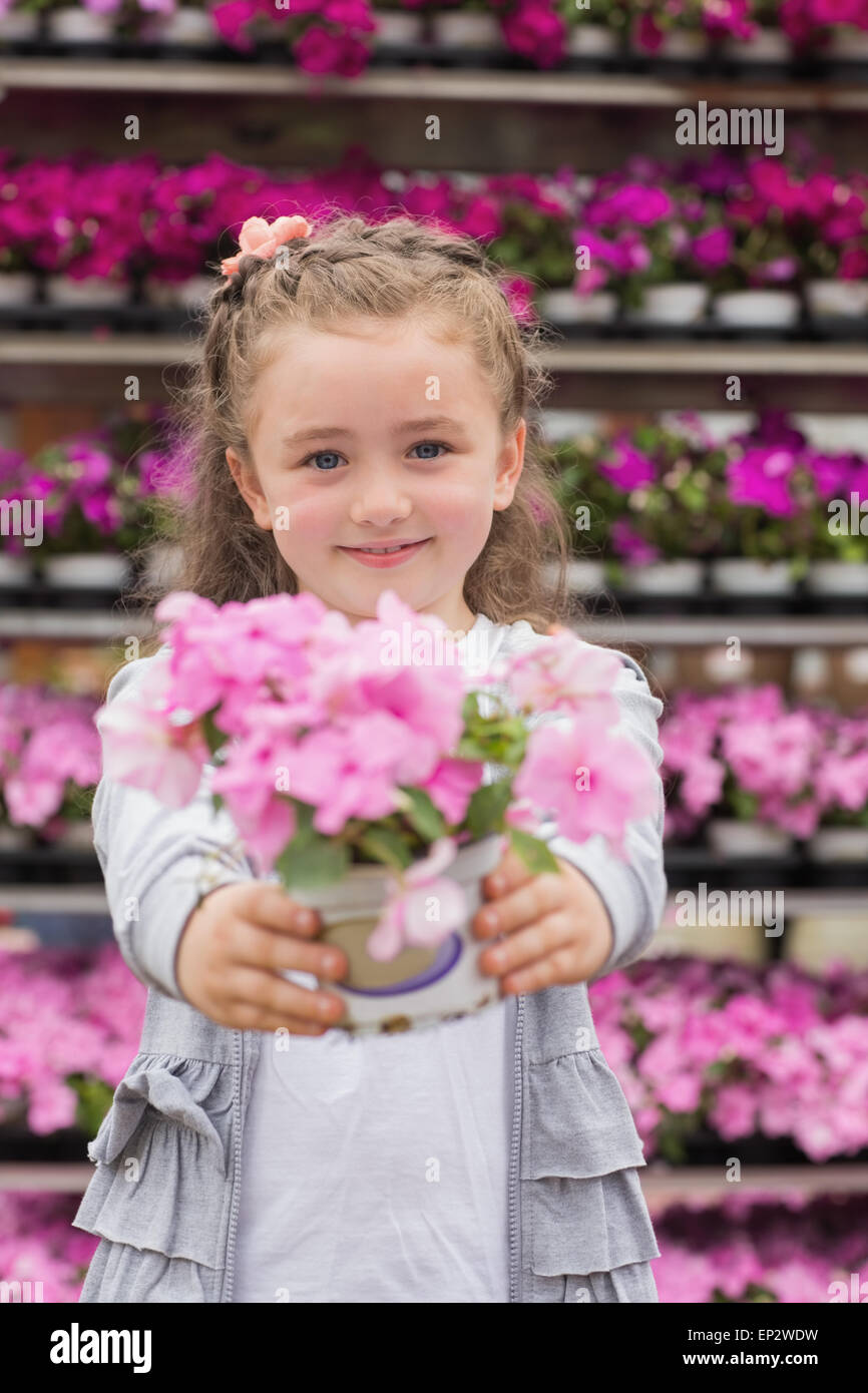 Little girl smiling and holding a flower pot Stock Photo - Alamy